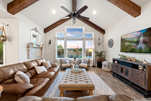 living room with vaulted ceiling with beams, light hardwood / wood-style floors, and ceiling fan