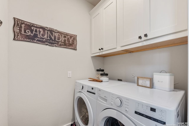 laundry area with washer and dryer and cabinets