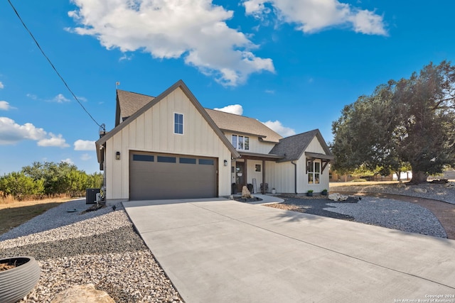 modern farmhouse with central AC unit and a garage