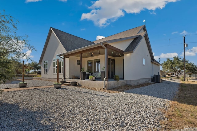 rear view of property with central air condition unit, a patio area, outdoor lounge area, and ceiling fan