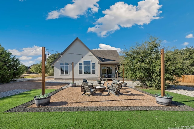 rear view of house with a patio and a lawn