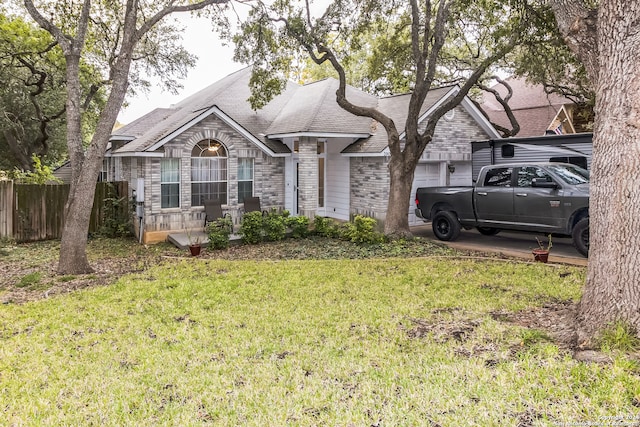 view of front of home with a front lawn and a garage