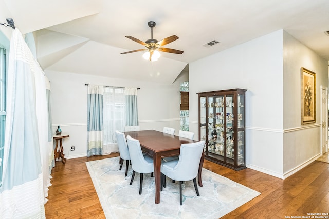 dining area featuring vaulted ceiling, hardwood / wood-style flooring, and ceiling fan