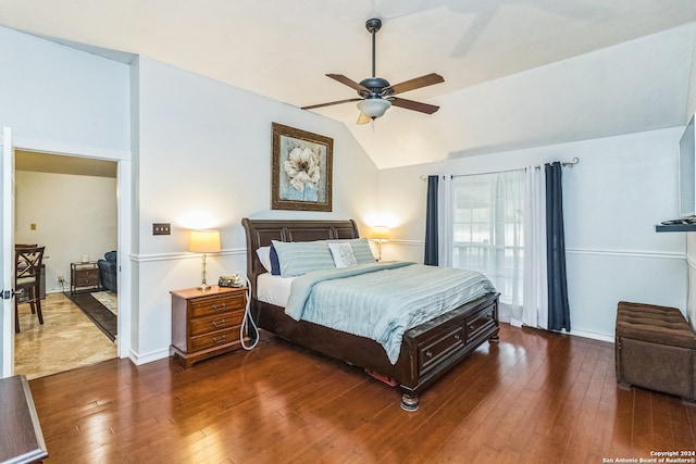 bedroom with dark wood-type flooring, ceiling fan, and vaulted ceiling