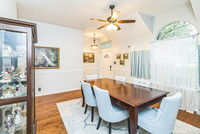 dining area featuring ceiling fan and dark hardwood / wood-style flooring