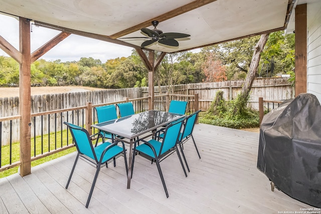 wooden deck featuring area for grilling and ceiling fan