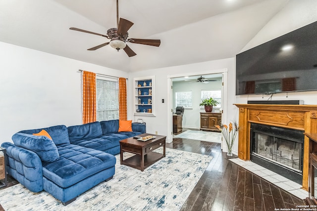 living room with ceiling fan, wood-type flooring, built in features, and vaulted ceiling