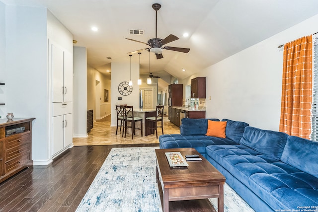 living room featuring dark hardwood / wood-style floors, ceiling fan, sink, and vaulted ceiling