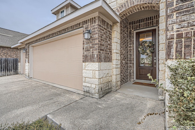 doorway to property with a garage