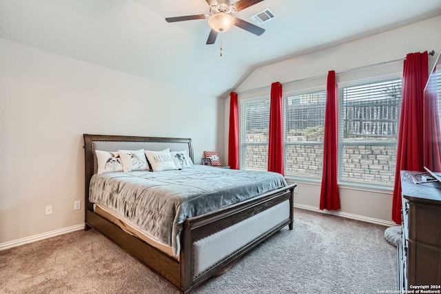 carpeted bedroom with ceiling fan and vaulted ceiling