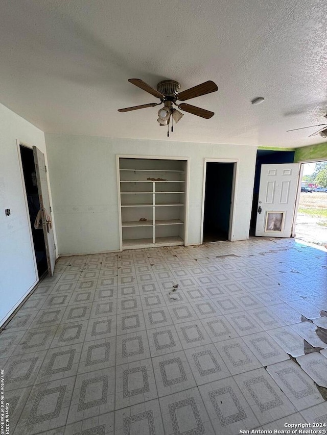 unfurnished bedroom with a textured ceiling and ceiling fan