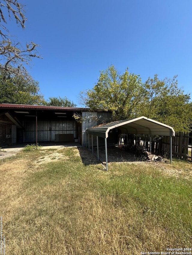 exterior space featuring a lawn and a carport