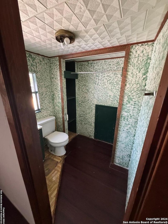 bathroom featuring toilet and a tile fireplace