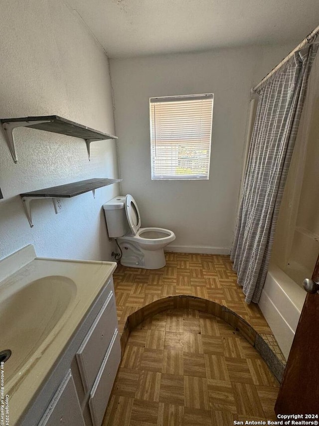 full bathroom with parquet flooring, vanity, shower / tub combo with curtain, and toilet