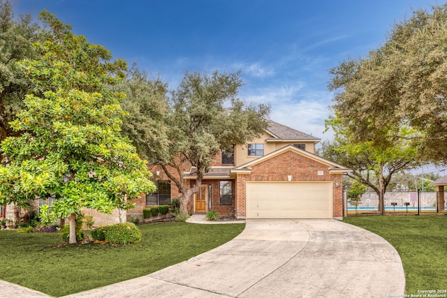 view of front of home featuring a front yard and a garage