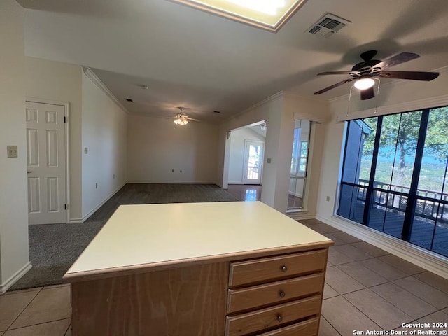 kitchen featuring a kitchen island, light tile patterned flooring, and ceiling fan