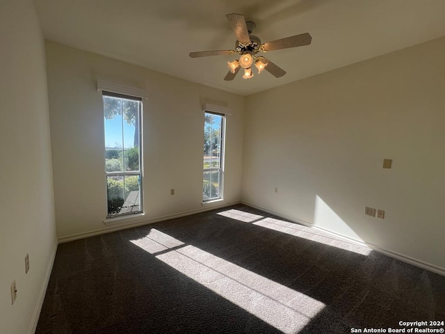 empty room with ceiling fan and carpet