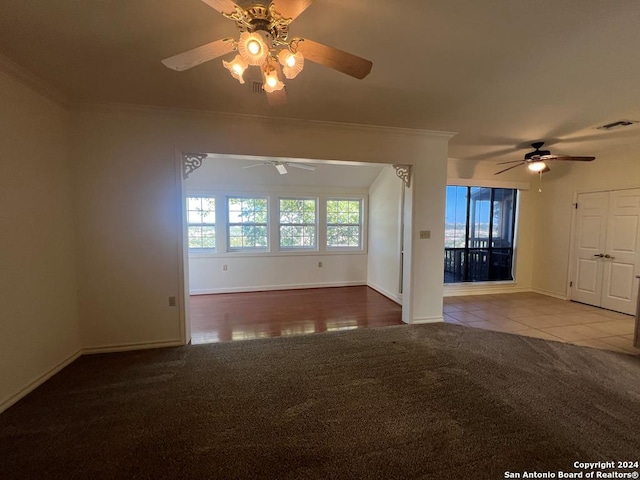 unfurnished living room featuring light carpet, crown molding, and ceiling fan