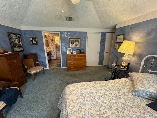 carpeted bedroom with connected bathroom, a closet, lofted ceiling, and ceiling fan