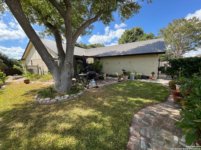 exterior space featuring a yard and a patio