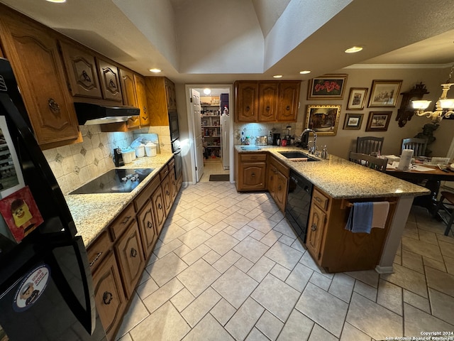 kitchen featuring black appliances, backsplash, crown molding, and sink