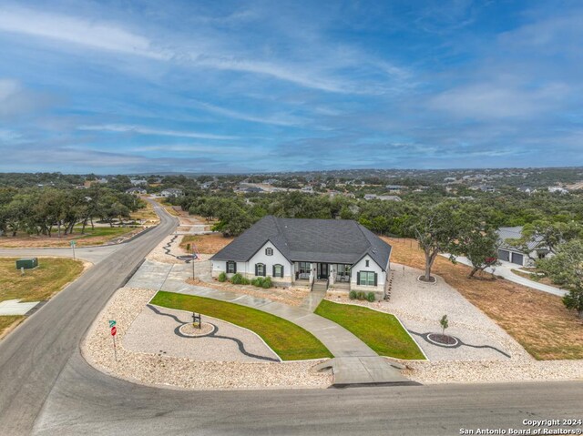 1207 Game Trl, New Braunfels, TX 78132 - view of subject property with a tree filled landscape