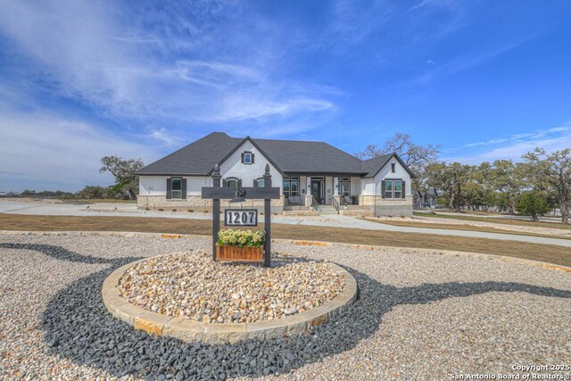 1207 Game Trl, New Braunfels, TX 78132 - back of house at dusk with an outdoor fire pit, a yard, a ceiling fan, a shingled roof, and a patio area