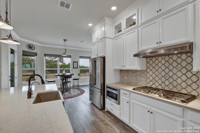 kitchen with visible vents, appliances with stainless steel finishes, under cabinet range hood, white cabinetry, and a sink