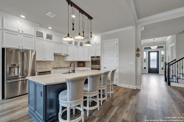 1207 Game Trl, New Braunfels, TX 78132 - dining area featuring crown molding, wood finished floors, and baseboards