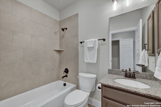 bathroom featuring baseboards, a textured wall, toilet, vanity, and washtub / shower combination