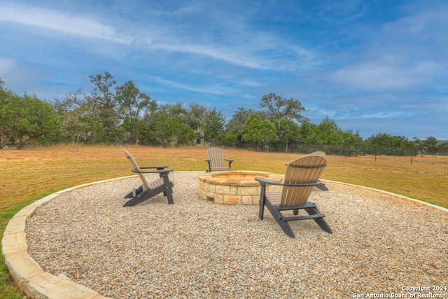 view of yard with a fire pit, a patio, and fence