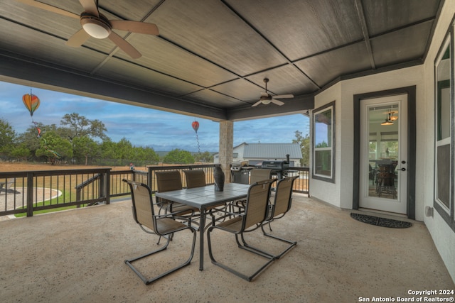 view of patio with outdoor dining area and ceiling fan