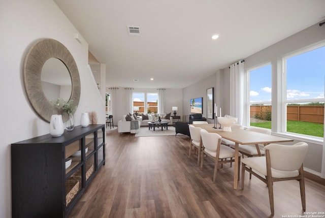 dining room featuring recessed lighting, baseboards, visible vents, and wood finished floors