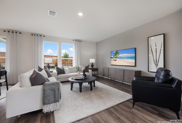living room featuring recessed lighting, a wealth of natural light, and dark wood-style floors