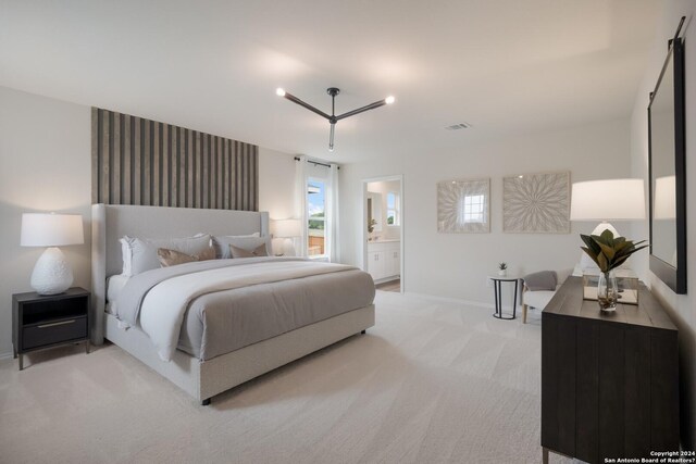 bedroom featuring visible vents, carpet flooring, baseboards, and ensuite bathroom