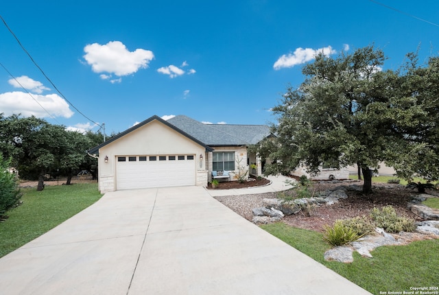 view of front of property featuring a garage and a front lawn