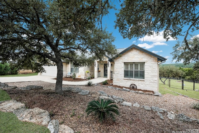 1138 Royal Eagle, Fischer, TX 78623 - view of front of home with a garage, driveway, stone siding, and fence