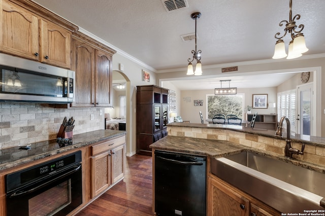 kitchen featuring a chandelier, dark hardwood / wood-style floors, black appliances, pendant lighting, and sink