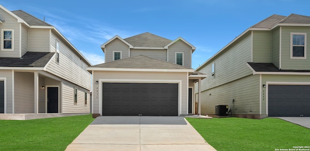 view of front of house with a front yard, a garage, and central air condition unit