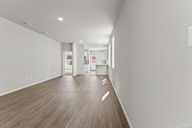 unfurnished living room with wood-type flooring