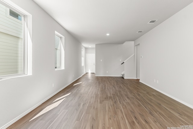 unfurnished room with hardwood / wood-style floors