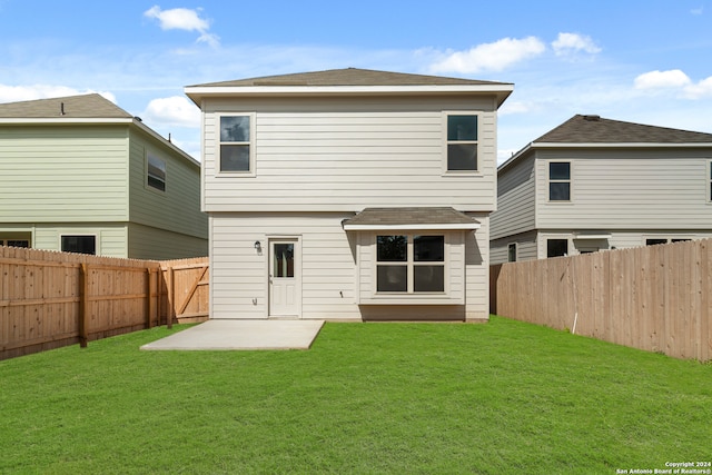 rear view of property with a patio area and a lawn