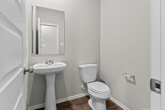 bathroom with sink, hardwood / wood-style flooring, and toilet