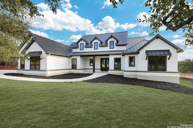 modern farmhouse style home with a front lawn