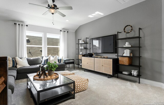 living room with ceiling fan, carpet flooring, and vaulted ceiling