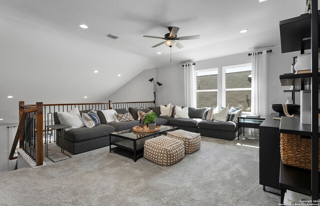 living room with lofted ceiling, light carpet, and ceiling fan