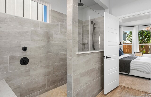 bathroom featuring tiled shower and hardwood / wood-style floors