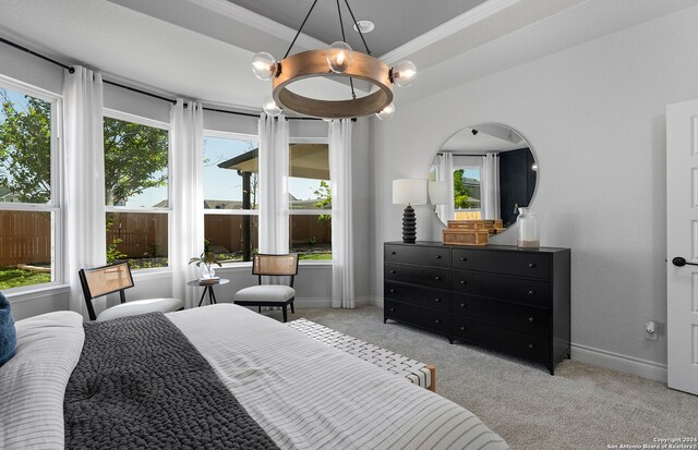 bedroom featuring ornamental molding, multiple windows, a chandelier, and light colored carpet