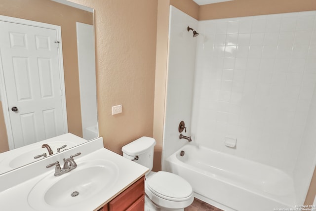 full bathroom featuring tiled shower / bath, vanity, and toilet