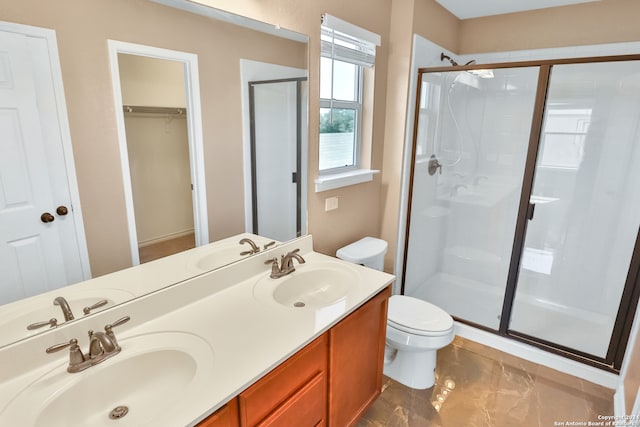 bathroom featuring vanity, toilet, and walk in shower